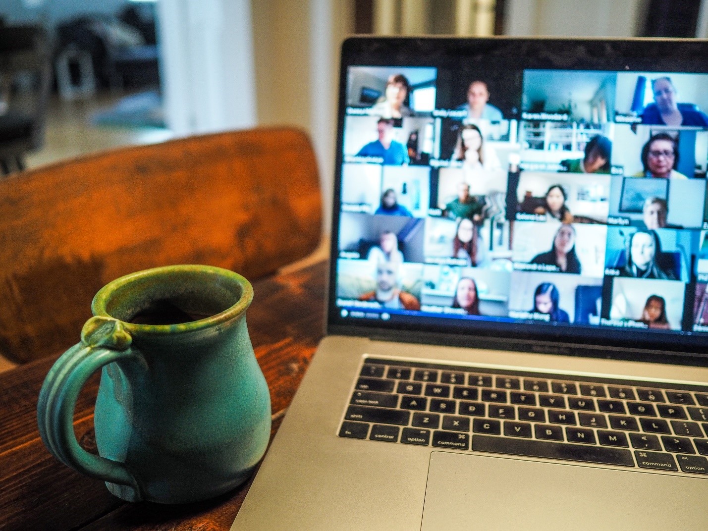 ThetaHealing online training An image of an online class running in the background shown on laptop screen with a green coffee cup